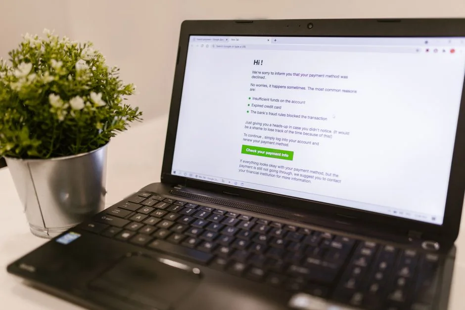 Person using smartphone for stock market analysis at home office.